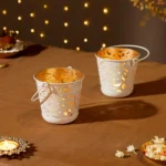 Amazon Brand – Solimo Tea Light Votive – Round Shape with Handle, White Powder-Coated Iron with Gold Interior, Set of 2 (Size: L-11 cm x W-11 cm x H-10 cm)